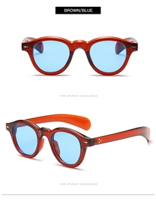 Macro shot of retro round amber frames with blue lenses and durable metal hinges