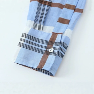 Light blue plaid ramie shirt dress showing detailed cuff texture and white button