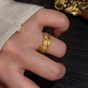 Vintage gold wrap ring with star and zircon details shown on finger