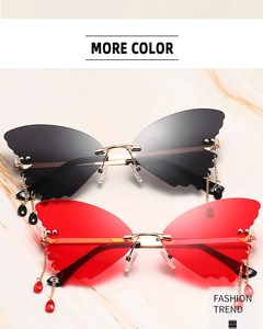 Detail of rimless butterfly sunglasses with gold chains and hanging crystal charms