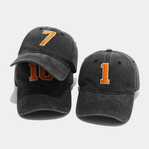Vintage washed dark grey baseball caps with embroidered orange numbers 7, 10, and 1