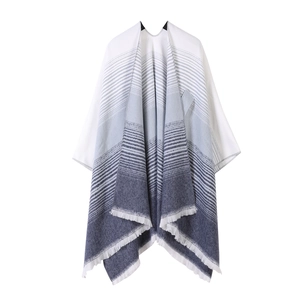 Close-up of blue and white gradient knitted shawl with stripe pattern and fringe detail