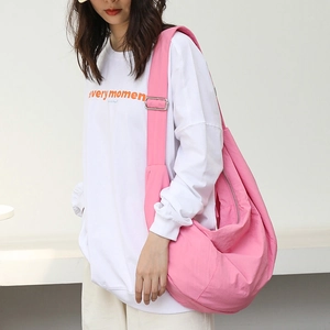 Pink nylon crossbody dumpling bag with adjustable shoulder strap for casual daily wear