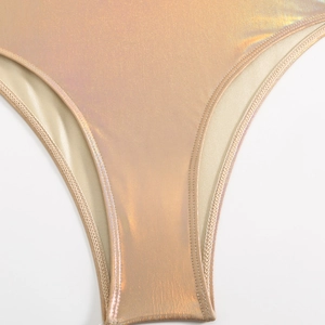 Detail of champagne gold holographic laser fabric with professional double stitching seam