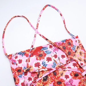 Detail of cross-strap back design on elegant floral print summer dress for women
