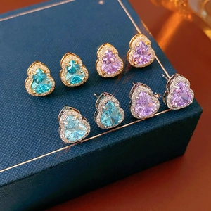 Detailed view of silver needle gourd earrings featuring blue and purple heart-shaped zircons