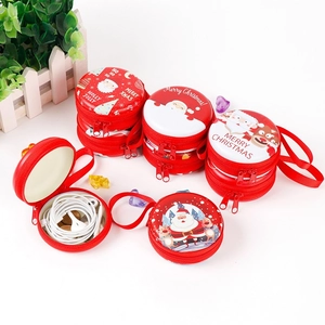 Round Christmas tin cases for candy and earphones featuring festive Merry Christmas prints