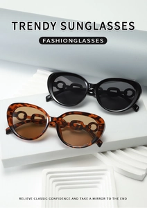 Close-up of trendy black and tortoiseshell cat eye sunglasses on geometric podium