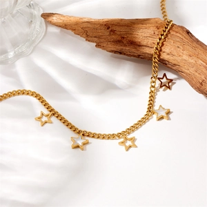 Detailed macro view of gold-plated star pendants with white shell inlay on a steel chain