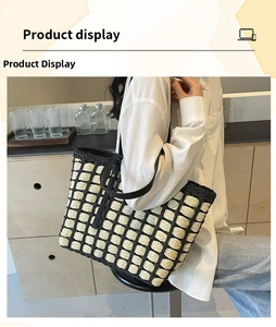 Close-up of contrast woven straw tote bag with black mesh weave and durable PU straps