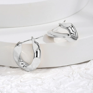 Minimalist silver geometric egg-shaped earrings with irregular twisted metal texture