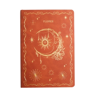 Orange faux leather planner featuring celestial gold foil sun and moon cover design