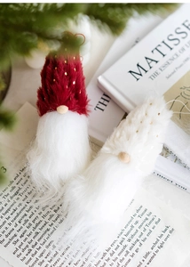 Detail of wool felt Christmas gnomes with glitter hats and soft fur for tree hanging