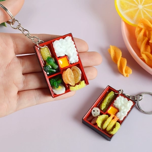 Miniature bento box keychain featuring resin white rice and tempura in a red container