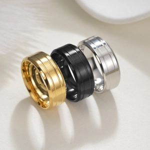Detailed view of 8mm wide polished stainless steel rings in gold, black, and silver