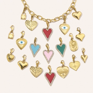 Detail of assorted gold plated heart pendants with colorful enamel and crystal accents