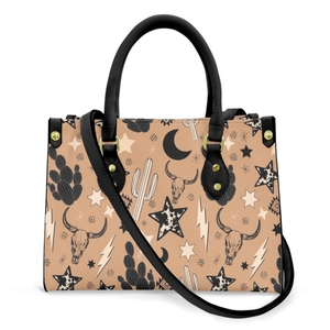 Detailed view of women's PU leather handbag featuring western cactus and bull skull prints