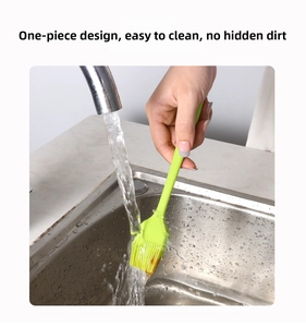 Waterproof silicone pastry brush being washed under tap water showing easy cleaning feature