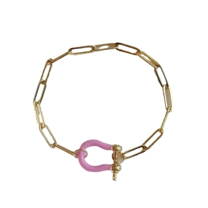 Gold paperclip chain bracelet featuring a pink enamel horseshoe U-link clasp for women