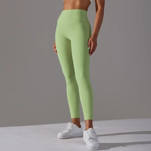 Detail of high-waist yoga leggings in lime green showing tummy control and fabric texture