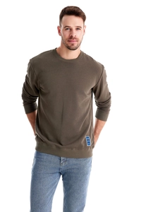 Detail of olive green sweatshirt showing ribbed crew neck and high-quality cotton texture