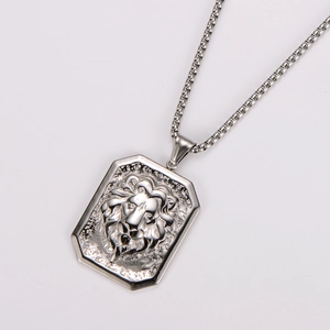 Detail of silver stainless steel hexagonal pendant with embossed lion head motif