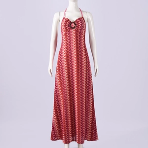 Detail of red and orange wavy knit maxi dress featuring a decorative chest ring