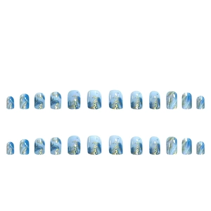 Blue marble press-on nails with gold foil accents and squoval shape in 24 piece set