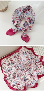 Detail of cotton linen scarf with floral print and vibrant magenta hemmed edges
