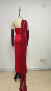 Detail of red satin backless evening gown with long gloves and sheer tulle shawl wrap