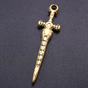 Macro detail of golden sword pendant featuring lion head carving and metallic texture