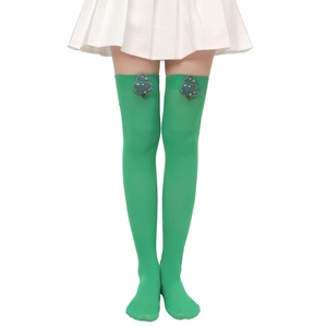 Detail of green Christmas thigh-high socks featuring a 3D plush Christmas tree attachment