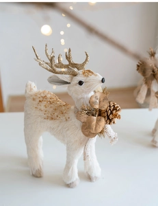 Close-up of decorative Christmas reindeer figurine with gold sequins and pine cones