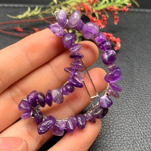 Detail of silver wire crescent moon hair clip with natural purple crystal stones