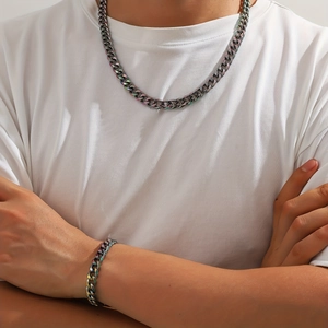 Close-up of iridescent Cuban link chain set showing colorful plating on necklace and bracelet