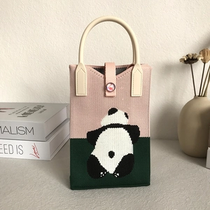 Pink and dark green knitted panda phone bag with beige handle and button detail