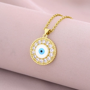 Detailed macro shot of an 18K gold evil eye pendant necklace with pavé zircon accents