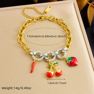 Detail of colorful charm bracelet with mixed gold links and fruit enamel pendants
