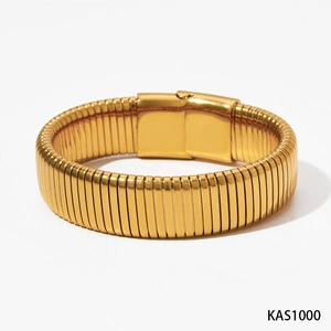 Minimalist gold-plated wide stainless steel bangle with a ribbed texture and clasp