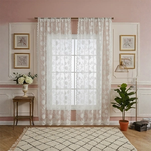Elegant white lace curtain with rose embroidery and scalloped edges in a modern room