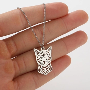 Detail of silver hollow cat pendant necklace showing fine line-cut animal facial details