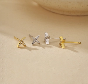 Macro shot of minimalist silver and gold star stud earrings with pavé cubic zirconia