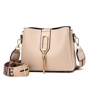 Chic apricot bucket bag with tassel detail and wide LOVE letter print shoulder strap