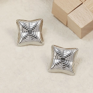 Polished silver square stud earrings with spiral textured finish on beige background
