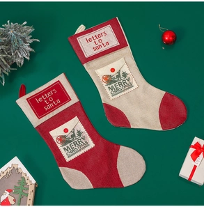 Flat lay of festive Christmas stockings with letters to Santa and merry Christmas text