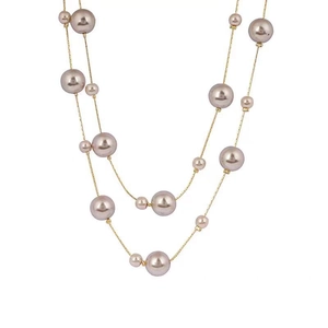 Double-layered gold pearl necklace with long chain design and champagne pearls