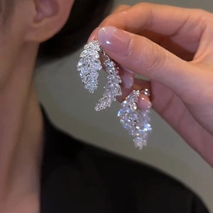Boucles d'oreilles feuilles en argent avec zircons étincelants montrées de profil
