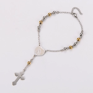 Detail of a religious heart medal with Medjugorje inscription and a silver cross pendant
