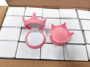 Detailed view of open pink crown velvet jewelry box showing interior structure and soft finish