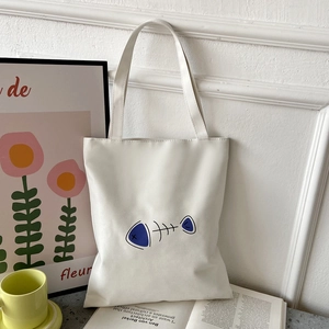 White Oxford canvas tote bag with minimalist fishbone print shown in a lifestyle setting